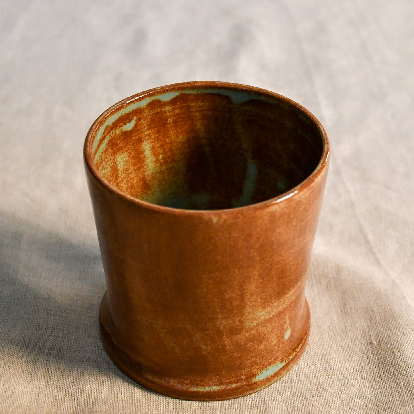 Handmade Heirloom Blue ceramic vessel by Leigh Art featuring chestnut brown and blue-green glaze variation, wheel-thrown stoneware accent piece from the Clayground collection.