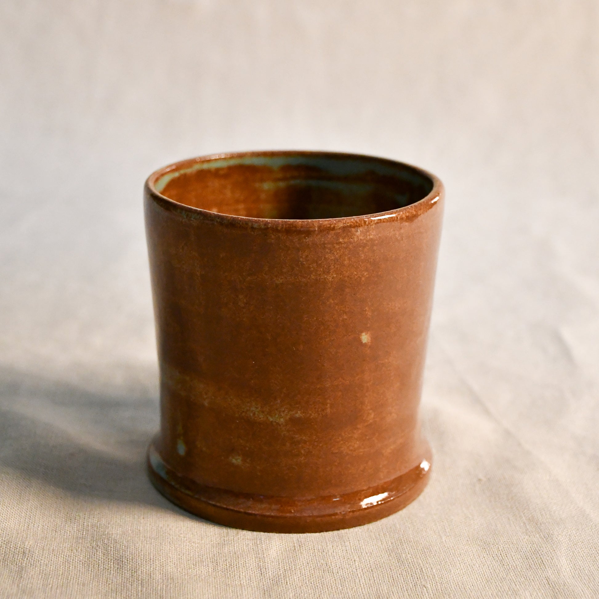 Handmade Heirloom Blue ceramic vessel by Leigh Art featuring chestnut brown and blue-green glaze variation, wheel-thrown stoneware accent piece from the Clayground collection.