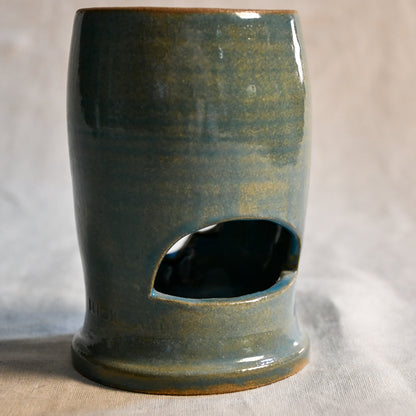 Back of wheel thrown ceramic lantern, hand carved Peony design and glazed in turquoise. 