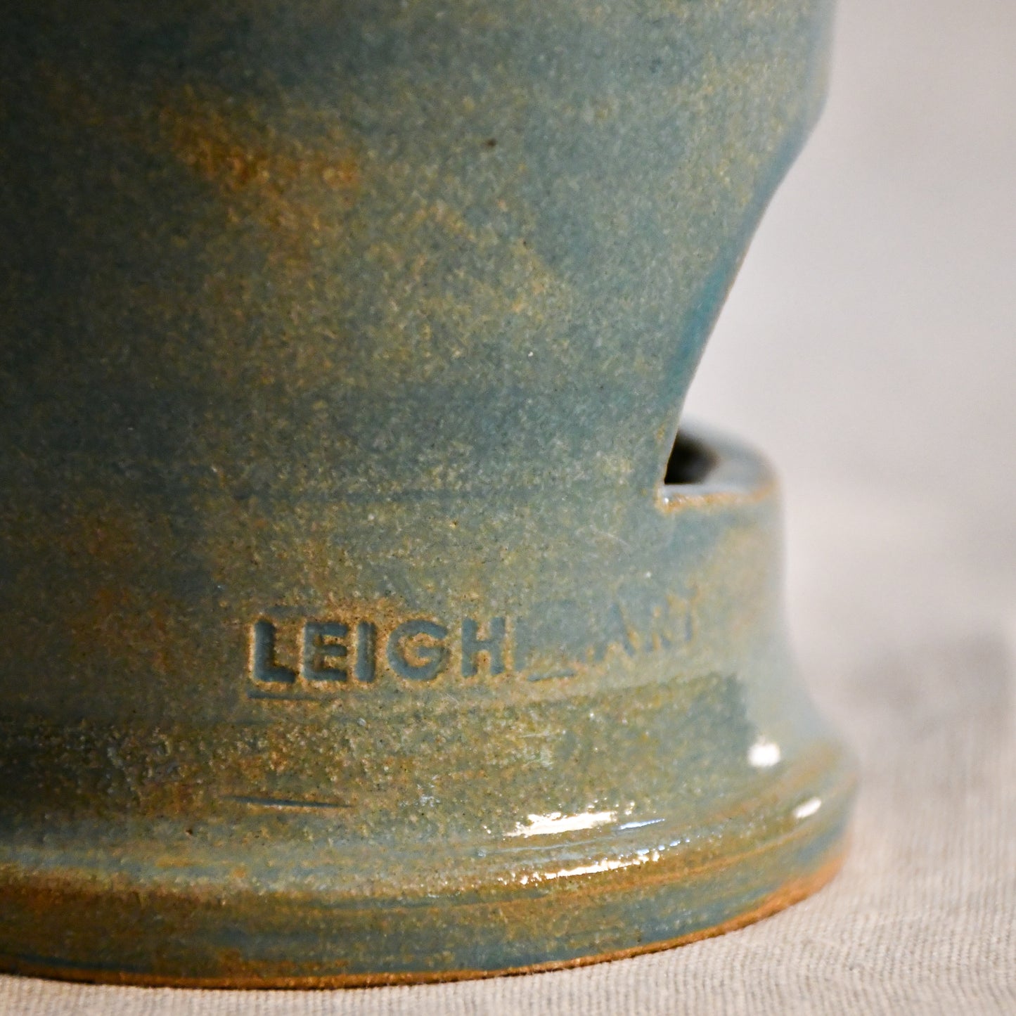 Close up of wheel thrown ceramic lantern, hand carved Peony design and glazed in turquoise. 