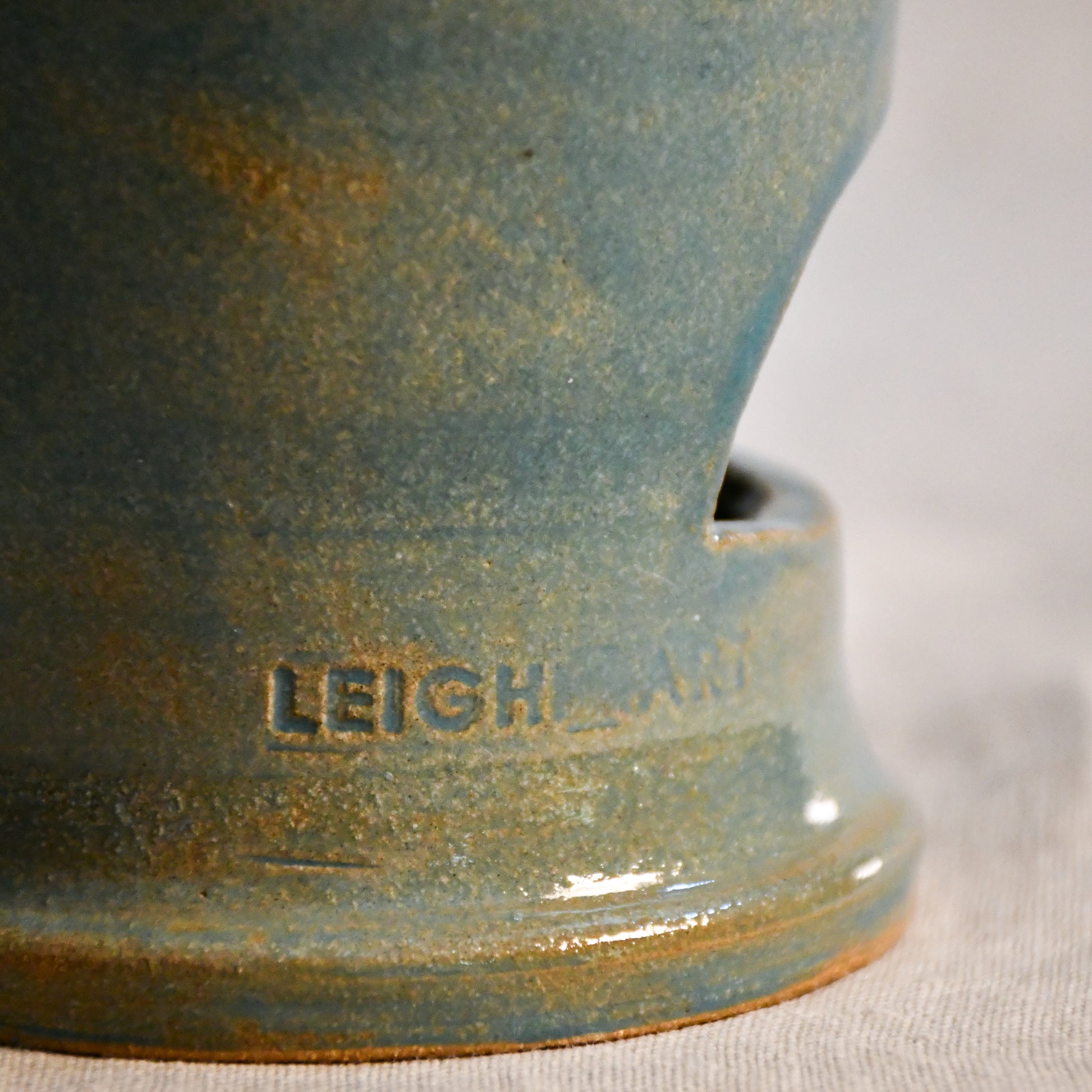 Close up of wheel thrown ceramic lantern, hand carved Peony design and glazed in turquoise. 