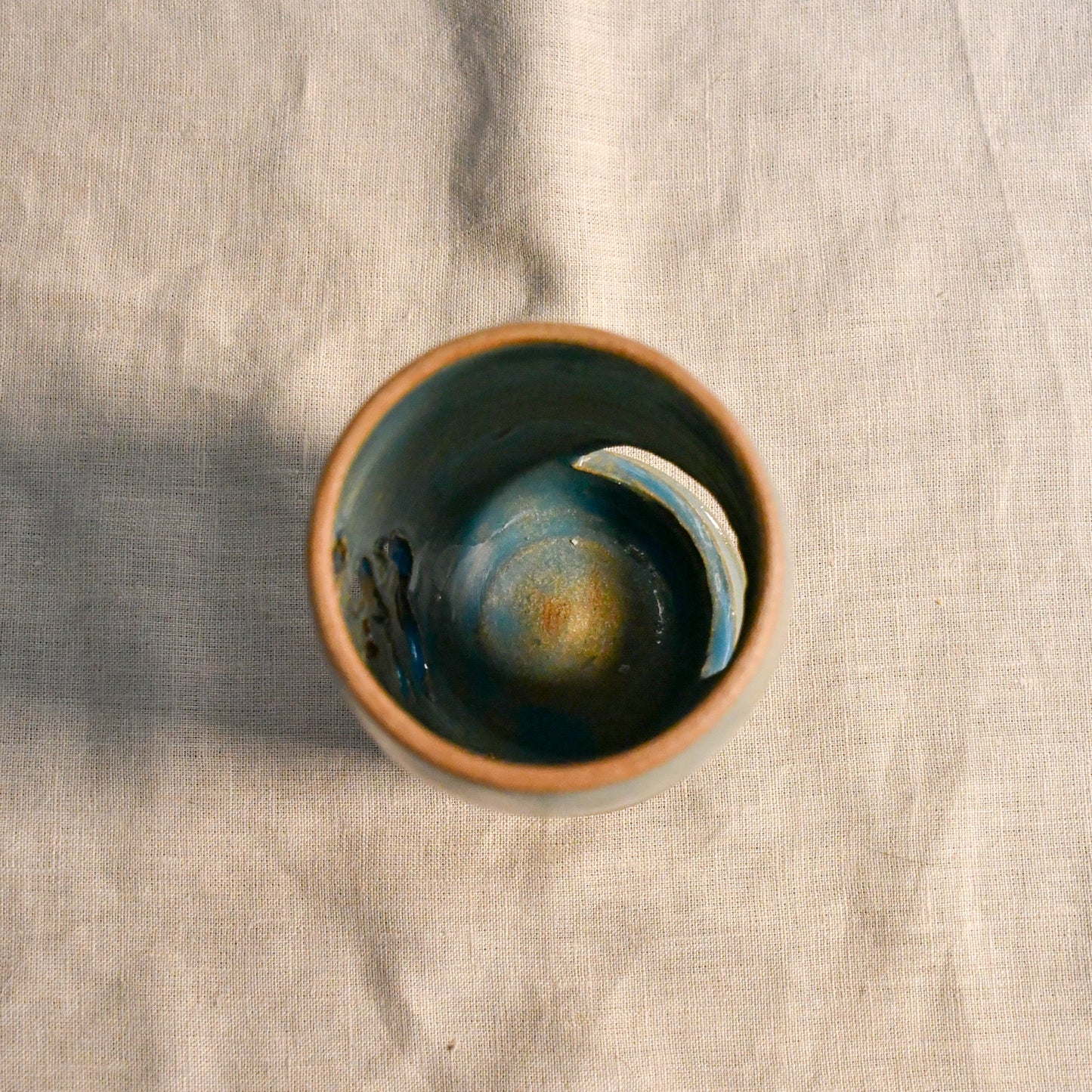 Top viewof wheel thrown ceramic lantern, hand carved Peony design and glazed in turquoise. 