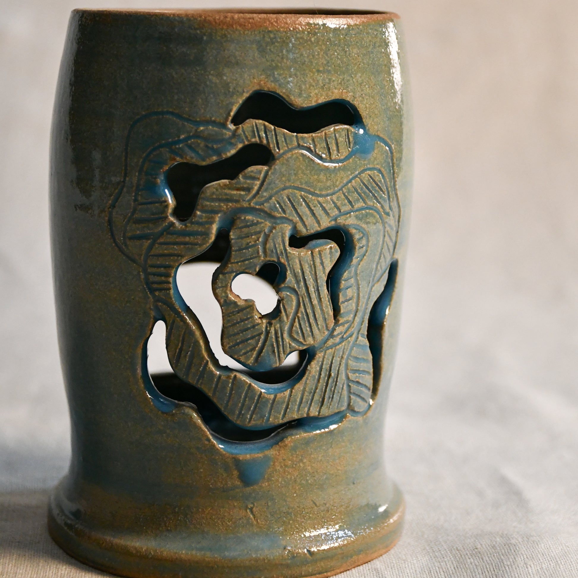 Wheel thrown ceramic lantern, hand carved Peony design and glazed in turquoise. 