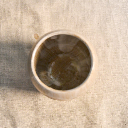 Top view of a white handmade wheel thrown, hand carved Peony design lantern fit for a tea light. 