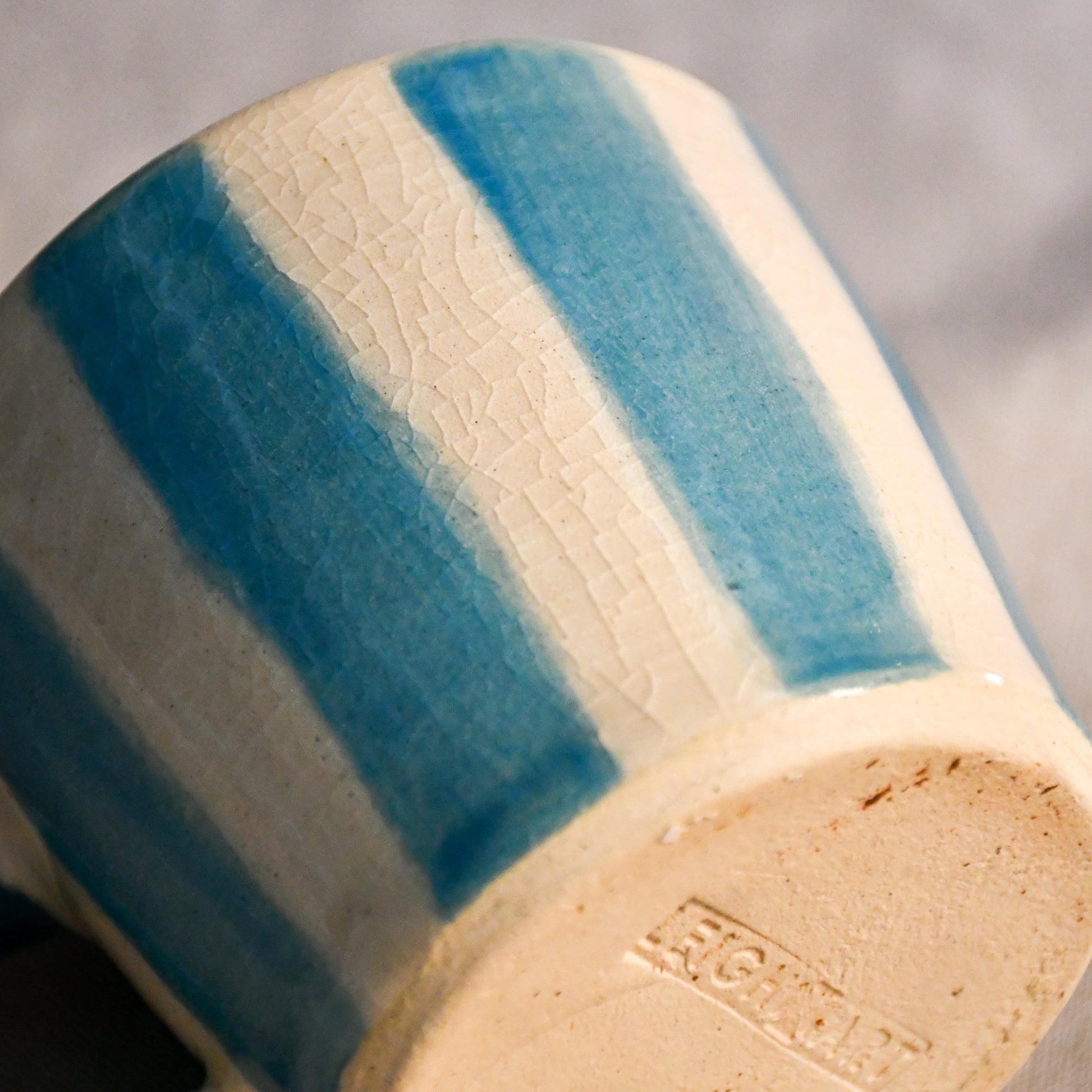 Turquoise striped mini espresso mug with hand-painted vertical bands and a vintage-inspired crackled glaze finish.