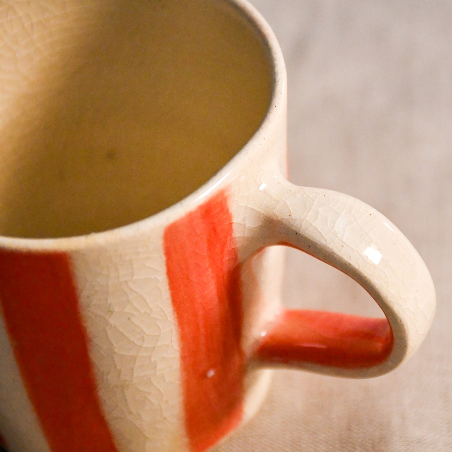 Handmade coral striped mini espresso mug with soft ivory stoneware and intricate crazing throughout the clear glaze finish.